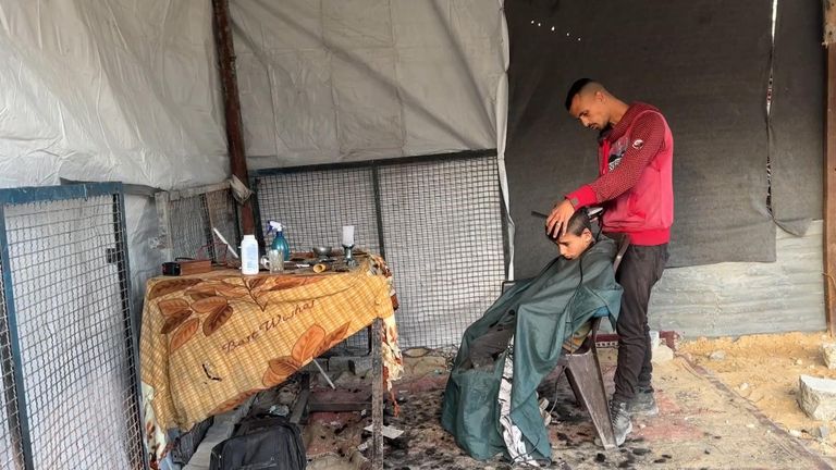A child gets his hair cut in Gaza