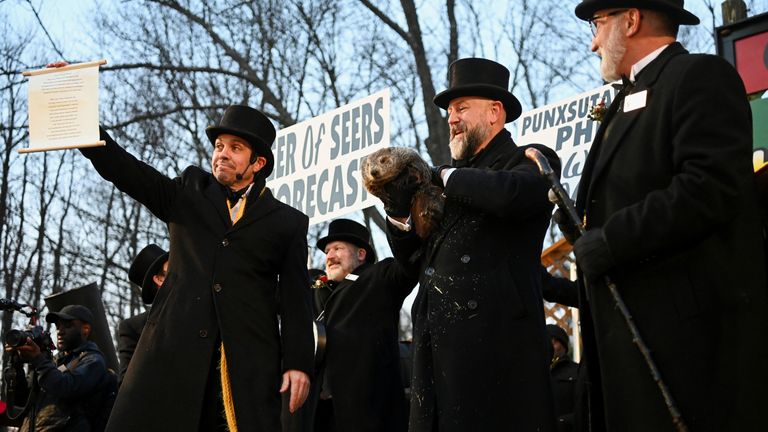 AJ Dereume holds up groundhog Punxsutawney Phil, as he makes his prediction on how long winter will last, during the Groundhog Day festivities, at Gobbler's Knob in Punxsutawney, Pennsylvania, U.S., February 2, 2025. REUTERS/Alan Freed

