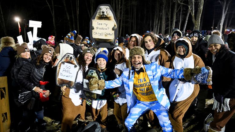 People pose with Groundhog Club’s Inner Circle Vice President Dan McGinley, on the day groundhog Punxsutawney Phil makes his prediction on how long winter will last, during the Groundhog Day festivities, at Gobbler's Knob in Punxsutawney, Pennsylvania, U.S., February 2, 2025. REUTERS/Alan Freed
