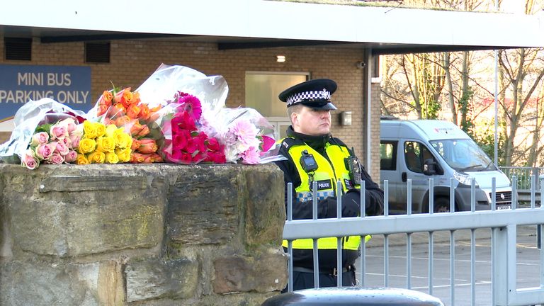 A police office stands near tributes outside the  All Saints Catholic High School, on Granville Road in Sheffield.
Pic: PA