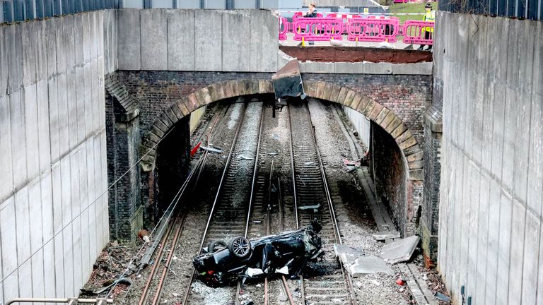 Travel chaos after car crashes on rail lines and driver arrested