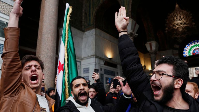 Syrian government supporters shout slogans to show their solidarity with the security forces who are fighting against gunmen loyal to former President Bashar Assad during a protest in Damascus, Syria, Friday, March 7, 2025. (AP Photo/Omar Sanadiki)