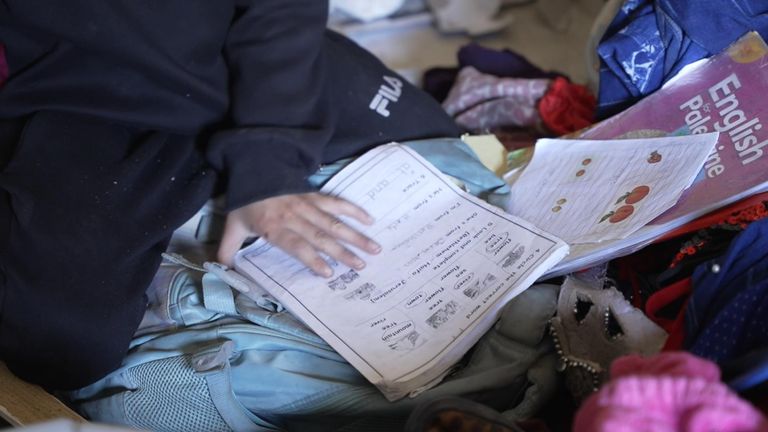 Sameer returned to the ruins of his home and found his tattered school books.