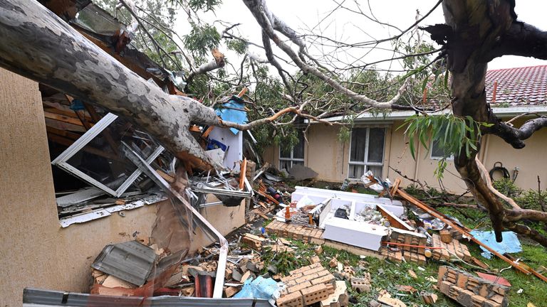 Debris lies at a damaged house by a fallen gum tree ahead of Tropical Cyclone Alfred's landfall, at Mudgeeraba on the Gold Coast, Australia.
Pic: AAP/Reuters
