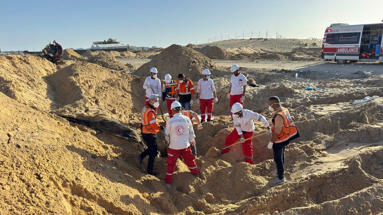 The search team retrieves the bodies of their colleagues from the mass grave, 30 March, 2025. Pic: UN