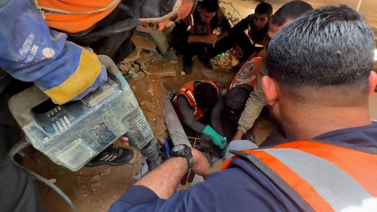 Palestinians drilling to try and reach the people trapped below the rubble