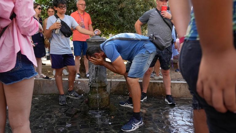 A man refreshes at a fountain in Rome, Monday, July 17, 2023. (AP Photo/Gregorio Borgia)