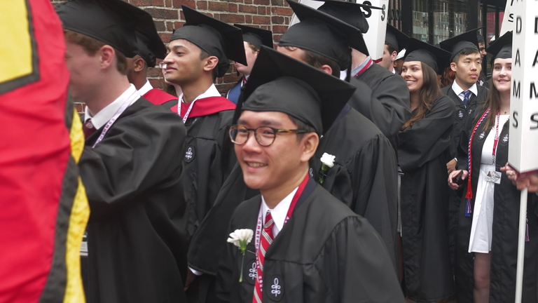 Some graduates were seen wearing white flowers in support of their international student peers