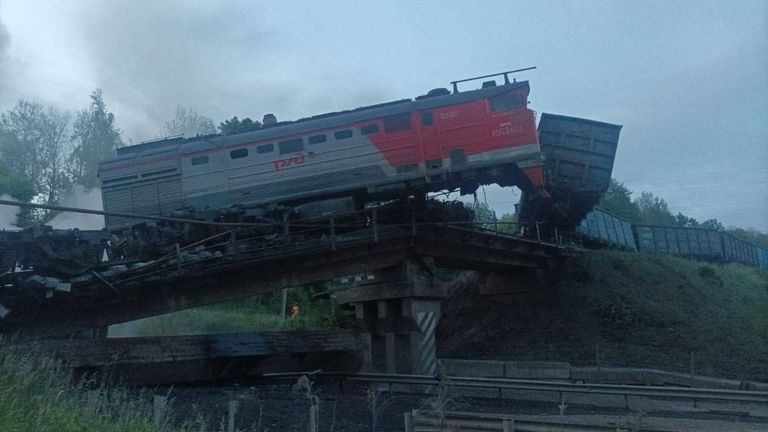 When a bridge collapsed in the Kursk region, part of the train fell down onto the road, and a fire started. Pic: RIA/Telegram